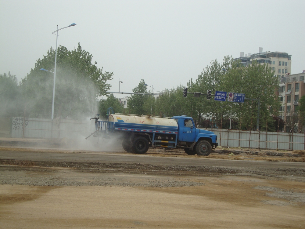 Китай, цистерната пръска рогозките с вода
